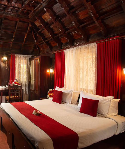 Well-furnished bedroom at Akanta Ayurveda Resort in India with modern amenities and serene views.

