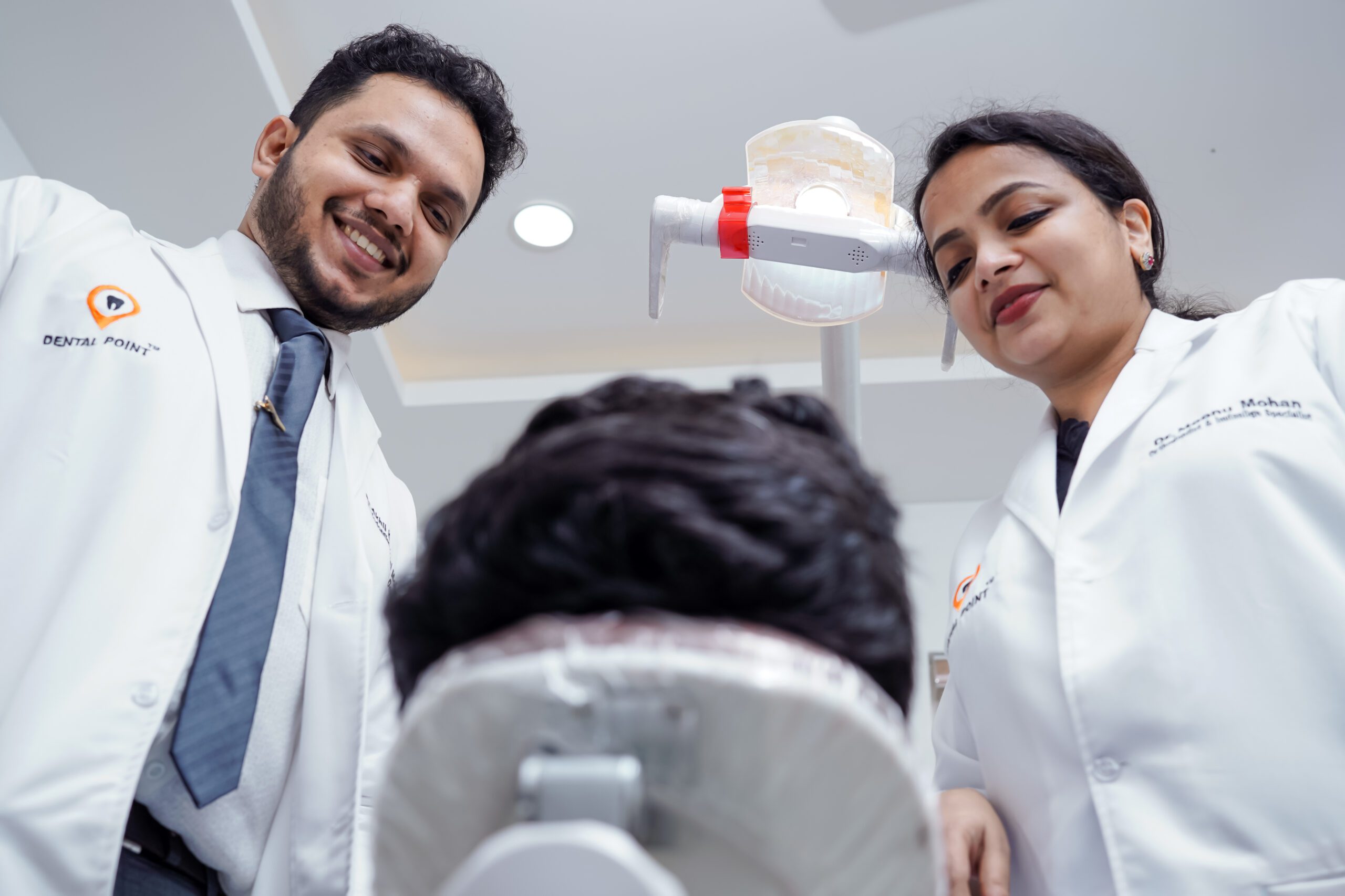 Experienced dentist consulting a patient at Dental Point
