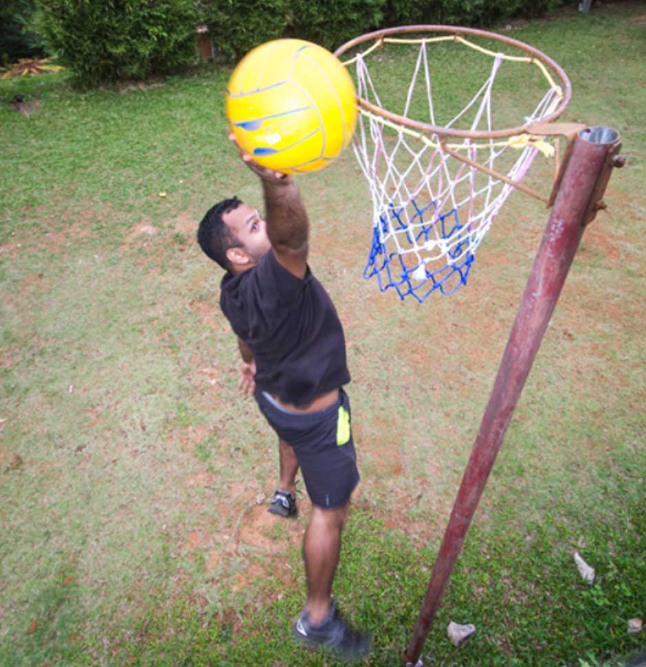 Basketball court at Misty Woods resort surrounded by lush greenery in Coorg
