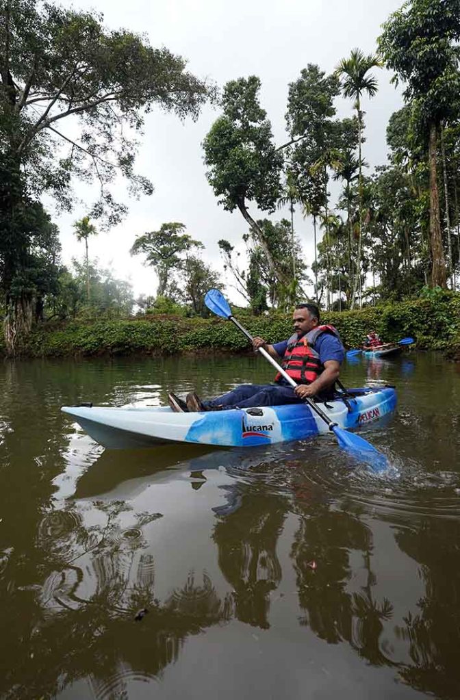 : Kayaking activity at Misty Woods Resort in Coorg surrounded by lush greenery and serene waters
