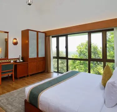 Elegant suite room at Morickap Resort, Wayanad with spacious living area, modern amenities, and scenic hill views – one of the top Wayanad resorts.