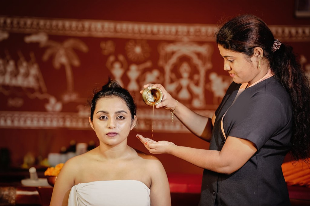 Authentic Ayurvedic treatment with herbal oils at a traditional Ayurveda resort in Kerala
