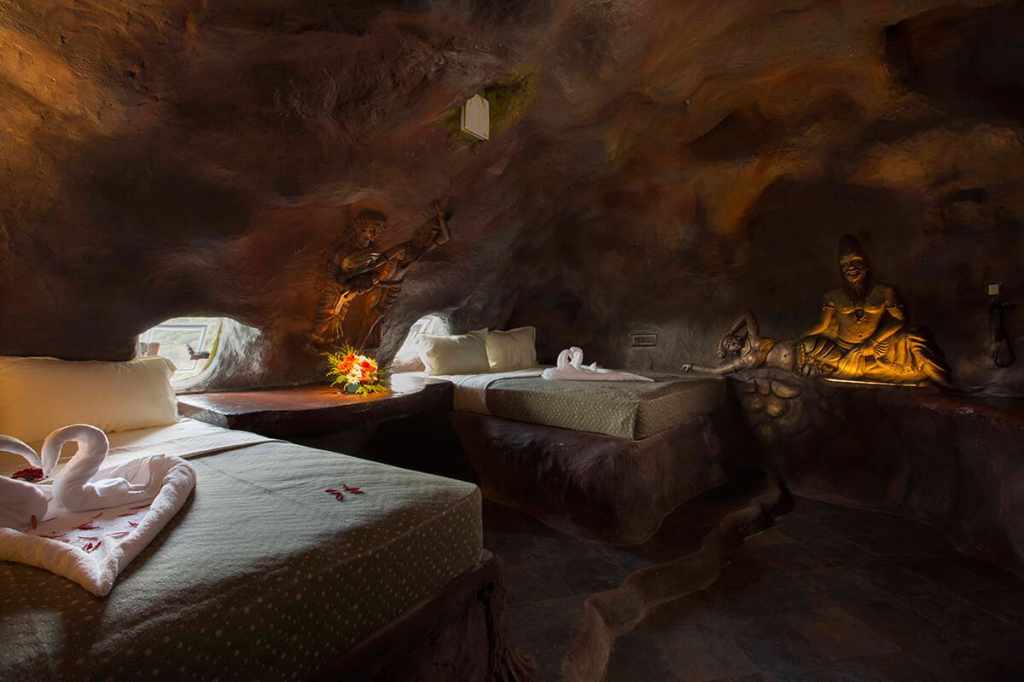 Premium cave room at Foggy Knolls Resort carved into mountainside with natural stone design and modern luxury interiors