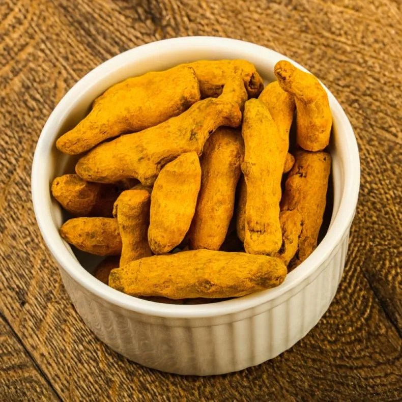 Organic turmeric from Kerala sourced by Maha Grand Spices, bright yellow dried turmeric with rich color and natural freshness.